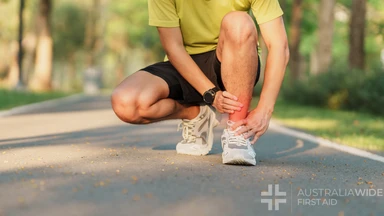 Young adult male with his muscle pain during running. runner man having leg ache due to Ankle Sprains or Achilles Tendonitis. Sports injuries and medical concept